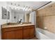 Bathroom boasts double sinks, granite countertop, and a bathtub at 8931 Bismarck Palm Rd, Kissimmee, FL 34747