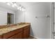 Bathroom with double vanity, granite countertop, and large mirror at 8931 Bismarck Palm Rd, Kissimmee, FL 34747