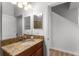 Bathroom with single sink vanity and a view of hallway and stairs at 8931 Bismarck Palm Rd, Kissimmee, FL 34747