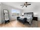 Primary bedroom with king bed, full-length mirror, and plenty of natural light at 8931 Bismarck Palm Rd, Kissimmee, FL 34747