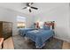 Twin bedroom with two beds, dresser, and ceiling fan at 8931 Bismarck Palm Rd, Kissimmee, FL 34747