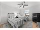 Twin bedroom with two beds, nightstand, and ceiling fan at 8931 Bismarck Palm Rd, Kissimmee, FL 34747