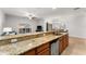 Granite kitchen island with breakfast bar seating at 8931 Bismarck Palm Rd, Kissimmee, FL 34747