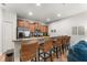Kitchen island with granite countertops and wicker stools at 8931 Bismarck Palm Rd, Kissimmee, FL 34747