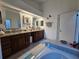 Bathroom with double vanity and a large soaking tub at 1022 Bartlett Ct, Oviedo, FL 32765