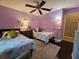 Charming bedroom with two twin beds and light purple walls at 1022 Bartlett Ct, Oviedo, FL 32765