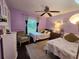 Bright bedroom featuring two beds and a window overlooking the garden at 1022 Bartlett Ct, Oviedo, FL 32765