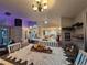 Open dining area with table, chandelier, and view of kitchen at 1022 Bartlett Ct, Oviedo, FL 32765