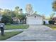 Tan house with white garage door and mailbox at 1022 Bartlett Ct, Oviedo, FL 32765