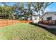 Large backyard with a wooden fence and deck at 1441 Dann St, Orlando, FL 32804
