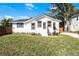 Charming bungalow with a renovated exterior, featuring a white facade and landscaped lawn at 1441 Dann St, Orlando, FL 32804
