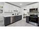 Updated kitchen featuring dark gray and white cabinets, quartz countertops, and stainless steel appliances at 1441 Dann St, Orlando, FL 32804