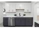 Modern kitchen with white and dark gray cabinets and a quartz countertop at 1441 Dann St, Orlando, FL 32804