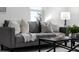 Cozy living room featuring a gray sofa, pillows, and a coffee table at 1441 Dann St, Orlando, FL 32804