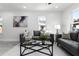 Modern living room with gray sofas, a glass coffee table, and a neutral rug at 1441 Dann St, Orlando, FL 32804