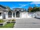 Modern house exterior, featuring a white facade, arched windows, and a paved driveway at 2224 Hoffner Ave, Belle Isle, FL 32809