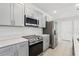 Modern kitchen with stainless steel appliances and an island at 2410 Park Ave, Indian Lake Estates, FL 33855