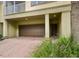 Attached garage with brick paver driveway at 2496 Grand Central Pkwy # 7, Orlando, FL 32839