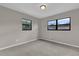 Simple bedroom with neutral walls, carpet, and two windows at 2533 Edgewater Ave, New Smyrna Beach, FL 32168