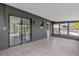 Sunroom features glass windows, tiled floor, and access to patio at 2533 Edgewater Ave, New Smyrna Beach, FL 32168