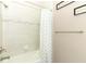 Bathroom with a shower/tub combo and gray patterned curtain at 3449 Michigan St, Lake Mary, FL 32746