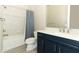 Bathroom with navy blue vanity and walk-in shower at 3449 Michigan St, Lake Mary, FL 32746