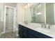 Modern bathroom with dark blue vanity and quartz countertop at 3449 Michigan St, Lake Mary, FL 32746