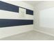 Bedroom with navy and white striped accent wall at 3449 Michigan St, Lake Mary, FL 32746