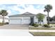 Two-story house with white exterior, three-car garage, and landscaped front yard at 3449 Michigan St, Lake Mary, FL 32746