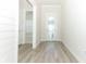 Bright foyer with white shiplap walls and wood-look tile floor at 3449 Michigan St, Lake Mary, FL 32746