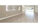 Living room with neutral walls, wood-look floors and large windows at 3449 Michigan St, Lake Mary, FL 32746