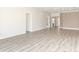 Open living area with wood-look tile floors and access to patio at 3449 Michigan St, Lake Mary, FL 32746