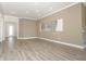 Open living room with neutral walls and wood-look tile floors at 3449 Michigan St, Lake Mary, FL 32746