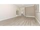 Open living room with shiplap wall and wood-look tile floors at 3449 Michigan St, Lake Mary, FL 32746