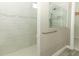 Walk-in shower with neutral tile and glass enclosure at 3449 Michigan St, Lake Mary, FL 32746
