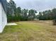 Spacious backyard with grassy area behind a single story house at 559 Marion Oaks Blvd, Ocala, FL 34473