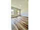Large bedroom with wood-look floors and two windows at 559 Marion Oaks Blvd, Ocala, FL 34473