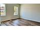 Well lit bedroom featuring hardwood floors and two large windows at 559 Marion Oaks Blvd, Ocala, FL 34473