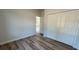 Bedroom with wood-look floors and a large closet at 559 Marion Oaks Blvd, Ocala, FL 34473