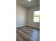 Bright bedroom with wood-look floors and a window offering natural light at 559 Marion Oaks Blvd, Ocala, FL 34473