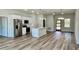 Open concept kitchen with island, stainless steel appliances, and light wood flooring at 559 Marion Oaks Blvd, Ocala, FL 34473