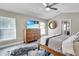 Spacious bedroom with a king-size bed, dresser, and large windows at 8048 Canyon Lake Cir, Orlando, FL 32835