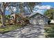 House exterior showcasing a two-car garage and lush lawn at 8048 Canyon Lake Cir, Orlando, FL 32835