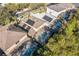 Aerial view of houses with solar panels and pools at 8458 Secret Key Cove, Kissimmee, FL 34747