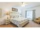 King-size bed, ceiling fan, and ensuite bathroom at 8458 Secret Key Cove, Kissimmee, FL 34747