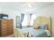 Comfortable bedroom featuring a queen bed and large windows at 8458 Secret Key Cove, Kissimmee, FL 34747