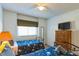 Bright bedroom with twin beds, dresser, and TV at 8458 Secret Key Cove, Kissimmee, FL 34747