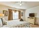 Bedroom with queen-size bed, TV, and dresser at 8458 Secret Key Cove, Kissimmee, FL 34747