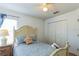 Charming bedroom with a queen bed and closet at 8458 Secret Key Cove, Kissimmee, FL 34747