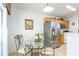 Breakfast nook with glass table and ornate chairs, adjacent to kitchen at 8458 Secret Key Cove, Kissimmee, FL 34747